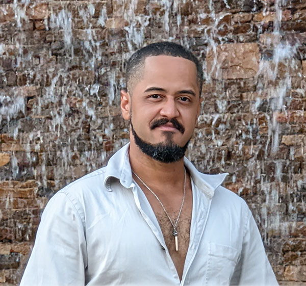 Sensei Stan beside a textured stone wall