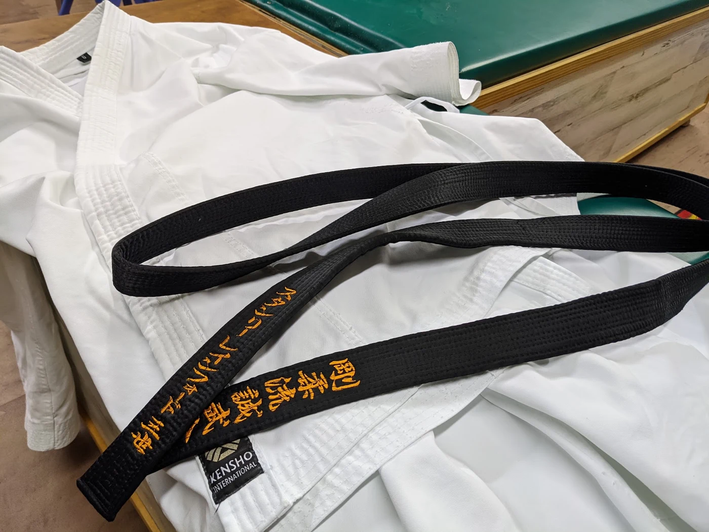 A black belt across a white karate uniform