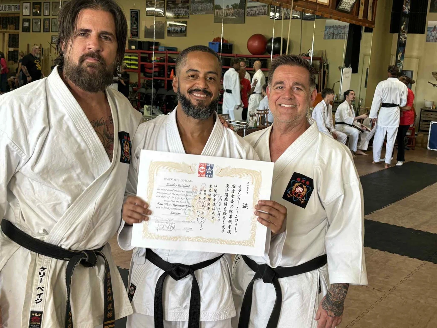 Sensei Stan holding his Sandan certificate with two other people
