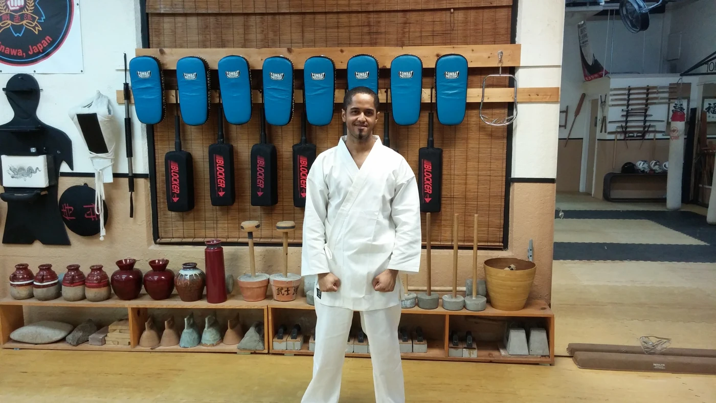 Sensei Stan practicing karate in a white uniform